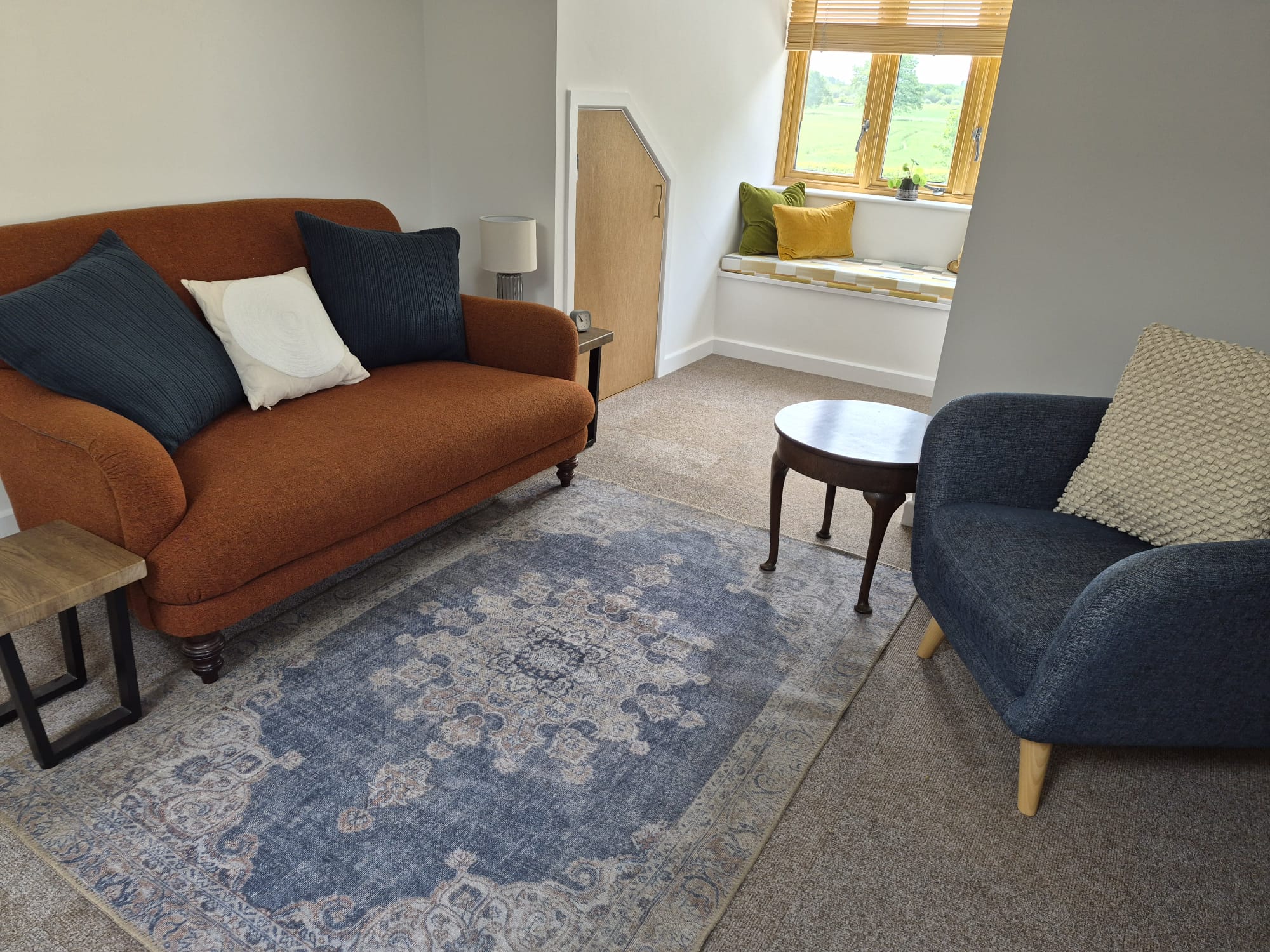 Seating area Seating area consisting of an orange couch for clients and a blue armchair for counsellor